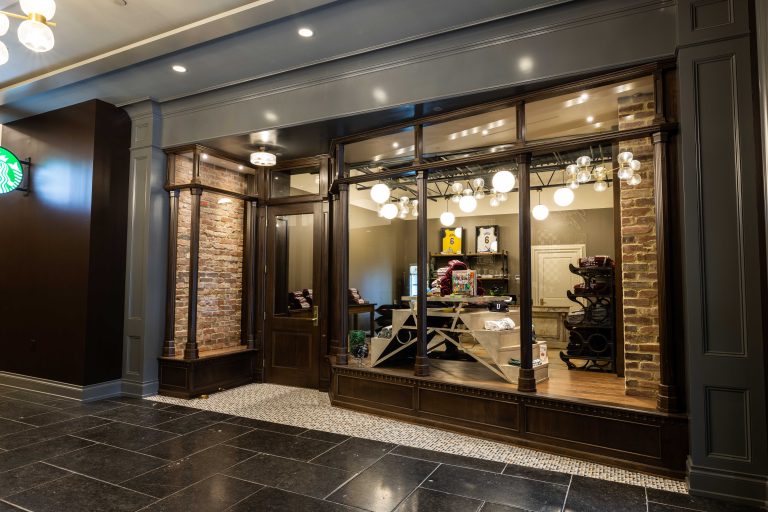 Retail store exterior lit up at night showing results of commercial electrical upgrade