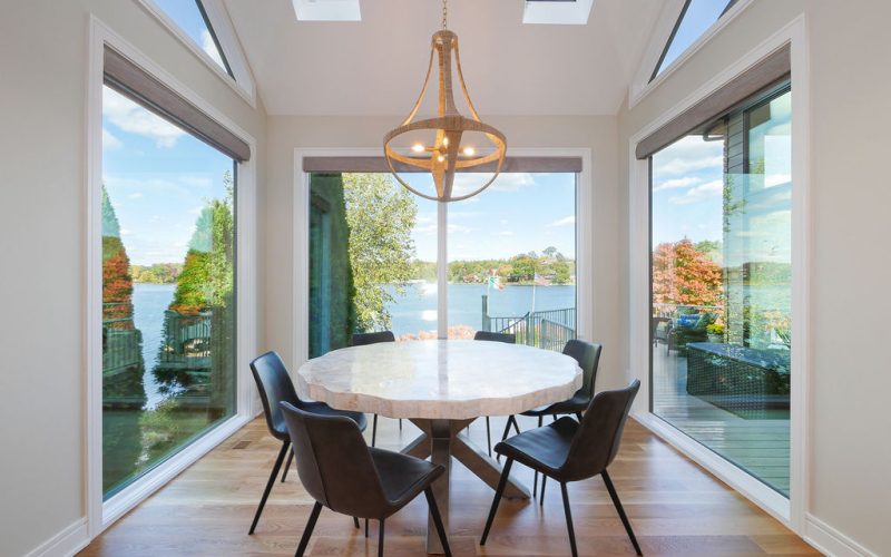 A breakfast nook in a modern home provides a beautiful space for recreation using a statement lighting piece.